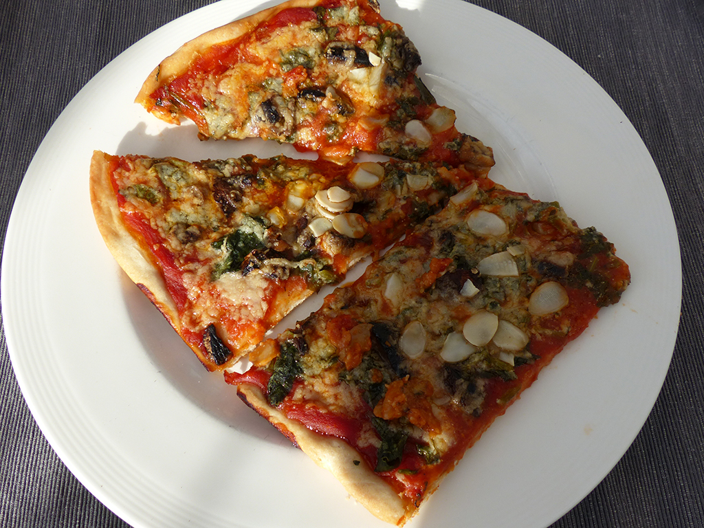 Pizza with mushrooms and kale